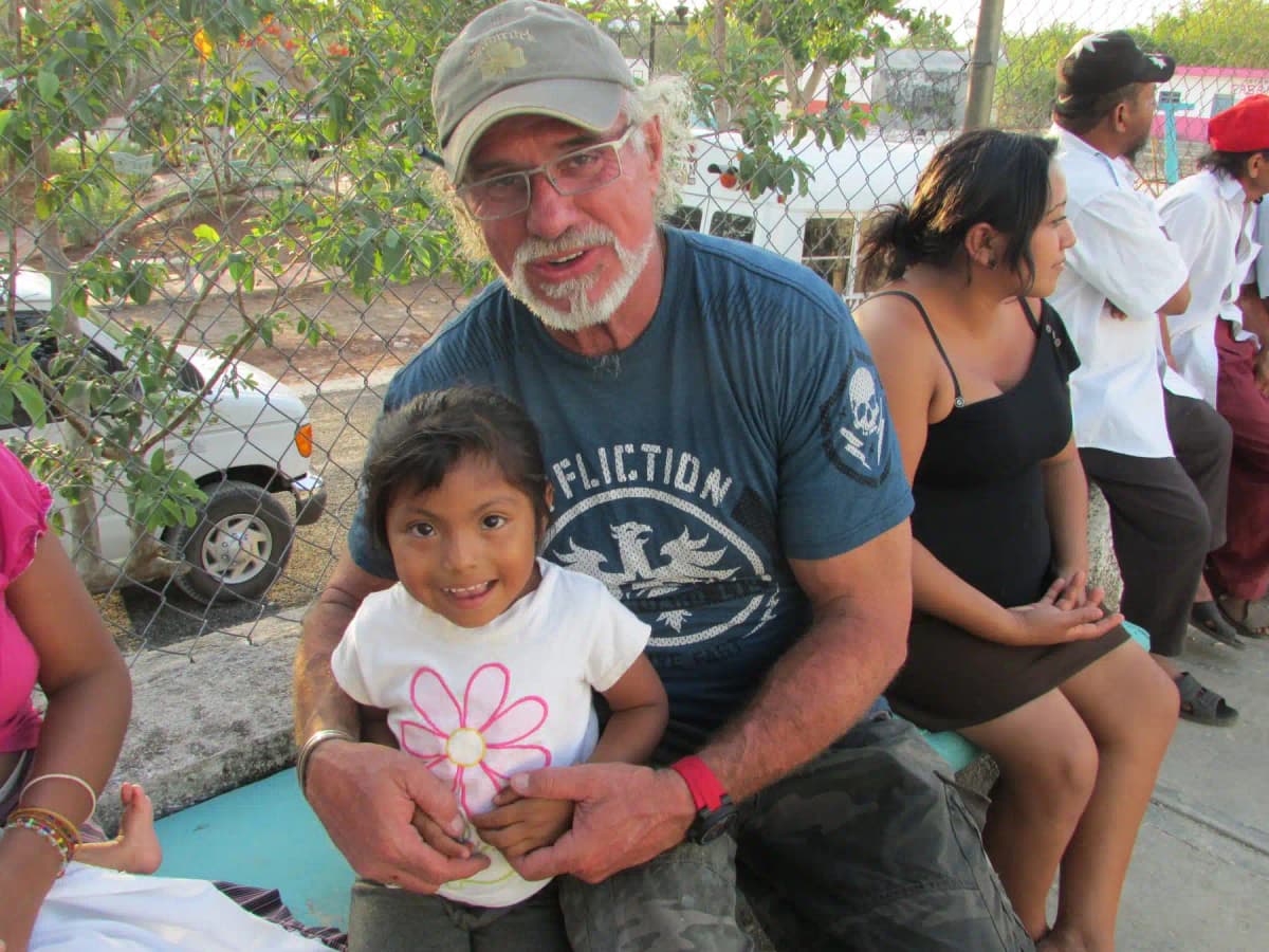 A Shamrock Plumbing volunteer with a child in the Yucatan Peninsula